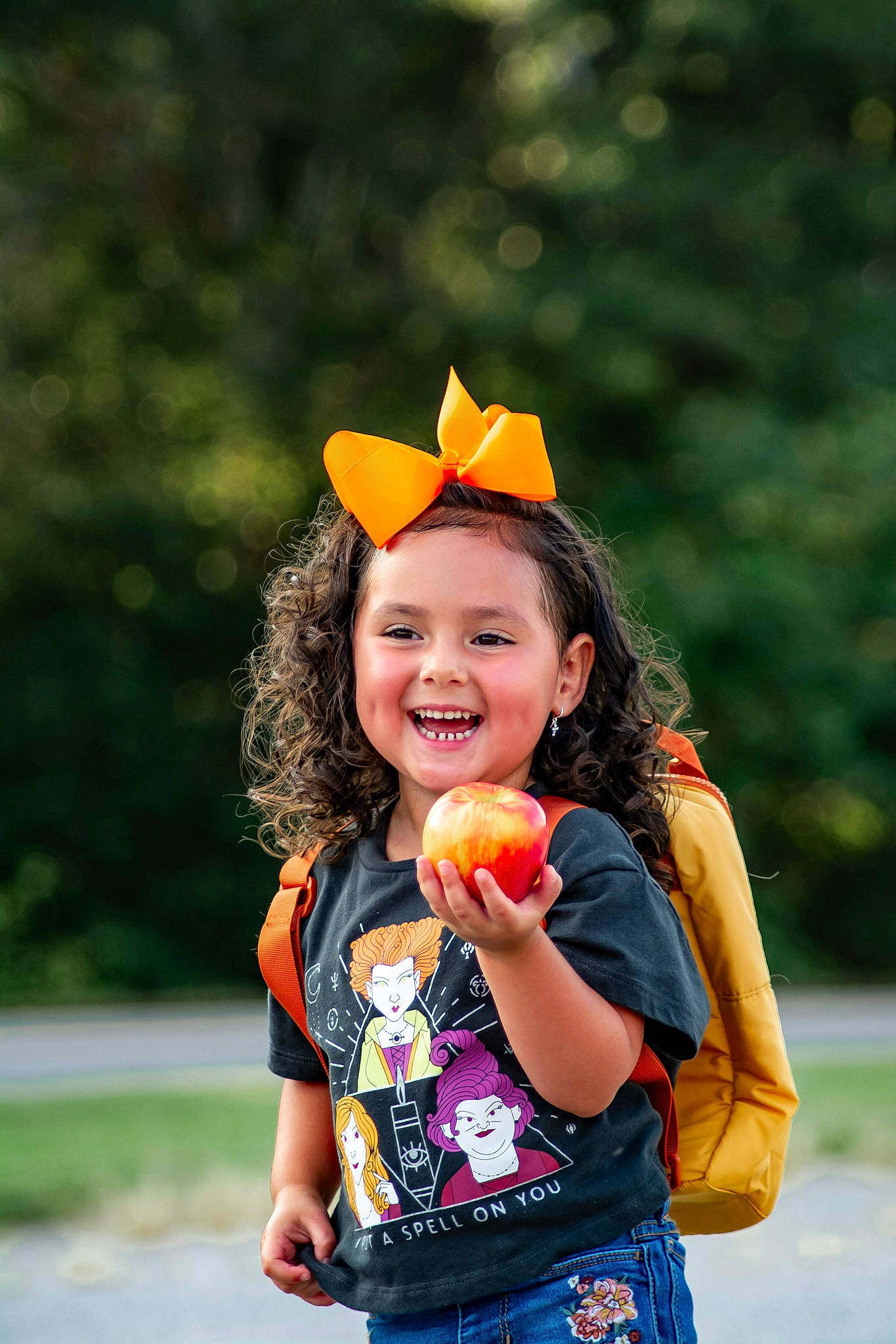 Kennedy is registered to the contest to win money with this photo: beauty, child, costume, eye, fruit, fun, gesture, glove, grass, happy, joy, leisure, orange, people_in_nature, person, plant, play, recreation, smile, spring