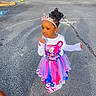 Kalanni joined the competition — help win amazing prizes! birthday_badge, car, child, colorful_clothing, curly_hair, cute, earrings, fashion, girl, outdoor, parking_lot, pavement, person, portrait, shadow, sneakers, standing, sunlight, tiara, tutu_skirt