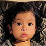 Emiliano joined the competition — help win amazing prizes! toddler, child, baby, portrait, face, eyes, wide_eyed, serious, sitting, cushion, chair, indoor, home, close_up, black_hair, gray_shirt, patterned_fabric, photography, head, safe