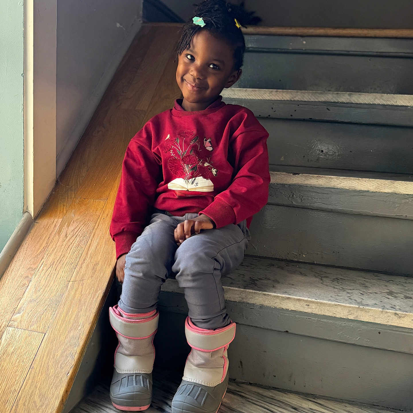 Melody is registered to the contest to win money with this photo: architecture, boy, building, child, clothing, face, footwear, handrail, hardwood, head, house, housing, male, pants, person, plywood, shoe, sitting, staircase, wood