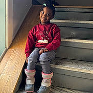 Melody is registered to the contest to win money with this photo: architecture, boy, building, child, clothing, face, footwear, handrail, hardwood, head, house, housing, male, pants, person, plywood, shoe, sitting, staircase, wood