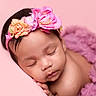 Amira joined the competition — help win amazing prizes! baby, sleeping, newborn, portrait, flower_crown, pink, purple, blanket, fluffy, close_up, peaceful, indoors, infant, curled_up, headband, soft_lighting, face, eyes_closed, baby_photography, cozy