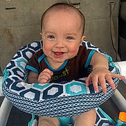 Lochlan joined the competition — help win amazing prizes! baby, baby_seat, blue, brown_shirt, cheeks, cute, eyes, face, hands, happy, indoor, infant, legs, patterned_fabric, portrait, skin, smile, tooth, toy, walker