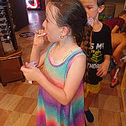 Novaliegh is registered to the contest to win money with this photo: child, girl, boy, indoor, colorful_dress, braid, floor_tiles, vending_machine, towels, water_bottles, black_shirt, yellow_shorts, people, candid, drink, store, sunglasses_display, person, kids, casual