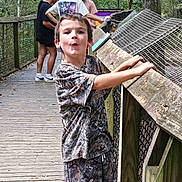Chevy joined the competition — help win amazing prizes! child, boy, camouflage_clothing, boardwalk, wooden_railing, nature, outdoor, trees, people, conversation, sign, greenery, shorts, tshirt, casual, daytime, park, expression, leisure, fun