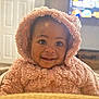 baby, child, hoodie, pink, smile, happy, indoor, face, expression, cute, warm_clothing, infant, portrait, fluffy, young_child, eyes, seated, cozy, soft_texture, person