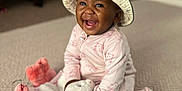 Missy K is registered to the contest to win money with this photo: baby, child, smiling, hat, bucket_hat, pajamas, toy, stuffed_animal, carpet, indoor, happy, playtime, infant, cute, person, face, sitting, colorful, mirror, soft_toys