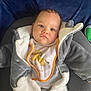Maël a rejoint le concours — aidez-le/la à gagner de superbes lots ! baby, blanket, clothing, coat, face, head, infantbed, jacket, person, photography, portrait, sitting, sleeve, stethoscope, toy