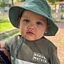 Maël participe au concours pour gagner de l'argent avec cette photo : baby, baseballcap, cap, clothing, face, grass, hat, head, nature, outdoors, pants, park, person, photography, plant, portrait, sunhat, t_shirt, tree, vegetation