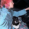 Arlo joined the competition — help win amazing prizes! cat, person, driver, passenger, car, vehicle, steering_wheel, road_trip, pink_hair, profile, tuxedo_cat, black_and_white, pet, animal, seated, seatbelt, sweatshirt, blanket, indoor, portrait