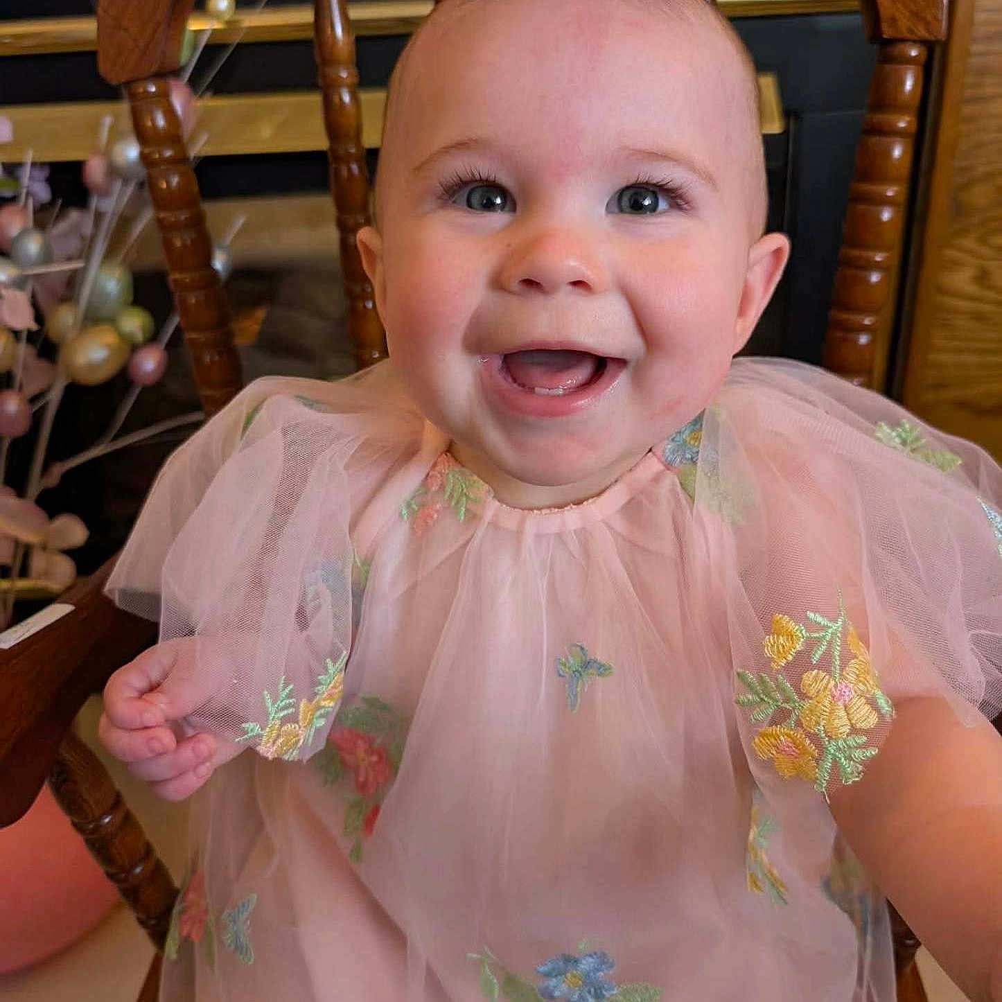 Charlotte joined the competition — help win amazing prizes! baby, child, smiling, pink_dress, embroidery, wooden_chair, happy, portrait, cute, indoor, face, young_child, toddler, sitting, apparel, person, closeup, cute_expression, celebration, adorable