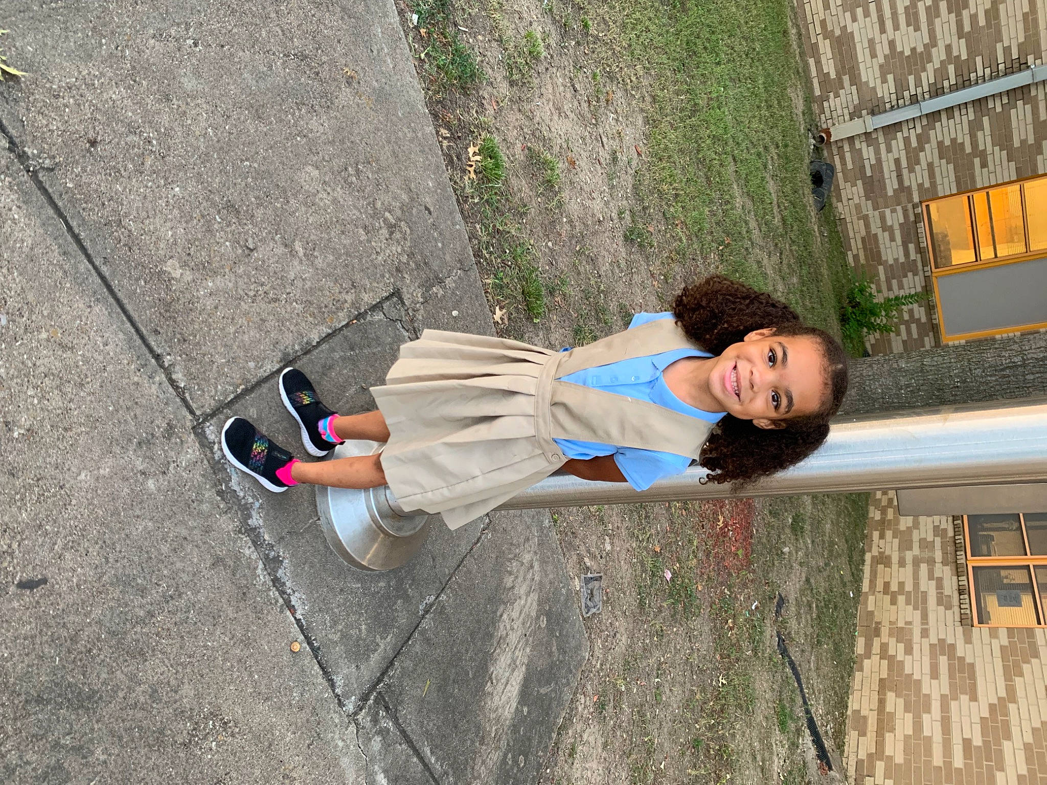 Brooklyn is registered to the contest to win money with this photo: asphalt, child, concrete, fun, grass, joy, leisure, pedestrian, person, plant, recreation, road_surface, shadow, sidewalk, sitting, soil, street_fashion, toddler, tree, walking_shoe