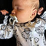 Bryson joined the competition — help win amazing prizes! baby, sleeping, pacifier, onesie, sheep_pattern, infant, child, face, hand, soft_texture, black_background, cute, peaceful, closeup, portrait, clothing, zipper, skin, head, newborn