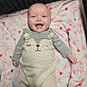 baby, smiling, blanket, pink, hearts, bunny_pattern, clothing, cozy, cute, infant, happy, lying_down, soft_texture, child, face, apparel, warm, indoors, adorable, portrait