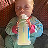 Trinity joined the competition — help win amazing prizes! baby, bottle, pajamas, sleepy, infant, hand, face, feeding, milk, indoors, blanket, pattern, child, person, cute, cozy, sitting, young, small, soft