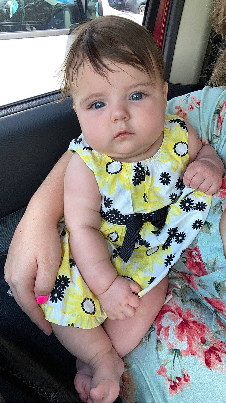 Juniper is registered to the contest to win money with this photo: arm, baby, baby_toddler_clothing, beauty, cheek, child, dress, eye, face, finger, hairstyle, happy, head, iris, neck, pattern, person, pink, skin, sleeve