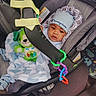 baby, baby_accessory, blanket, car_interior, car_seat, child, clothing, comfort, cute, hat, indoor, infant, person, plush_toy, portrait, seat_belt, soft_toy, toy, transport, young_child