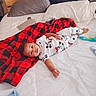 baby, bed, blanket, child, clothing, comfort, cozy, curious, cute, home, indoors, infant, lying_down, mickey_mouse, pajamas, person, pillow, resting, sleepwear, soft