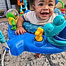 activity_center, baby, blue, carpet, child, colorful, cute, face, foot, furniture, hand, happy, home, indoor, infant, person, play, smiling, toy, young