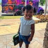 Aaliyah joined the competition — help win amazing prizes! toddler, child, tablet, porch, curly_hair, tongue_out, white_top, denim_shorts, socks, green_case, bus, purple, outdoor, daylight, playful, sidewalk, plants, trees, street, fun
