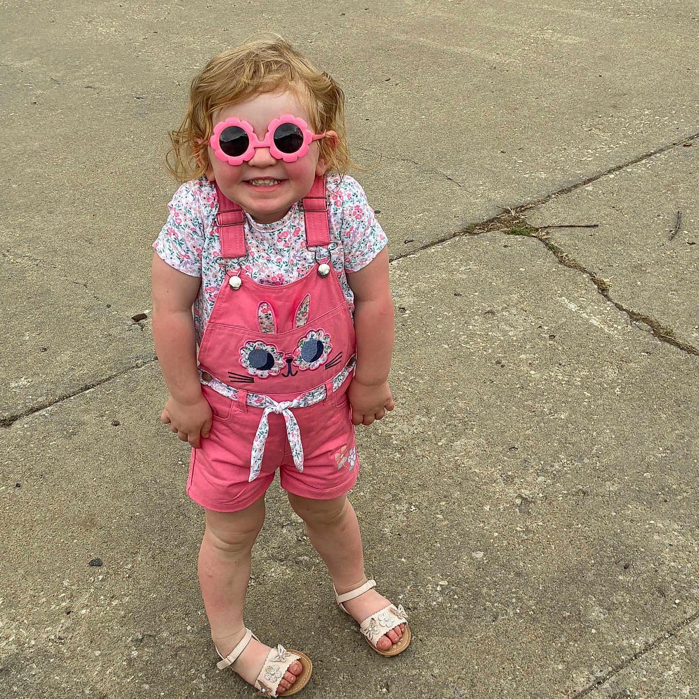 Kennslley joined the competition — help win amazing prizes! bunny_design, casual, child, concrete, cute, fashion, footwear, girl, happy, kid, outdoor, pink_overalls, playful, sandals, shorts, smiling, standing, summer, sunglasses, tshirt