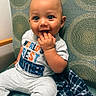 Kiel joined the competition — help win amazing prizes! baby, child, smiling, sitting, shirt, clothing, patterned_chair, hand, fingers, face, eyes, indoor, cute, happy, young_child, plaid_cloth, fabric, portrait, infant, playful
