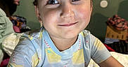 Kona joined the competition — help win amazing prizes! bedroom, calendar, child, closeup, cute, eyelashes, face, furniture, hair, happy, indoors, lemonade, pajamas, pattern, person, portrait, seated, shirt, skin, smile