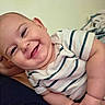 Jasper is registered to the contest to win money with this photo: baby, child, smile, happy, face, infant, striped_shirt, skin, cheeks, arm, hand, person, closeup, cute, joy, portrait, indoor, human, young, expression