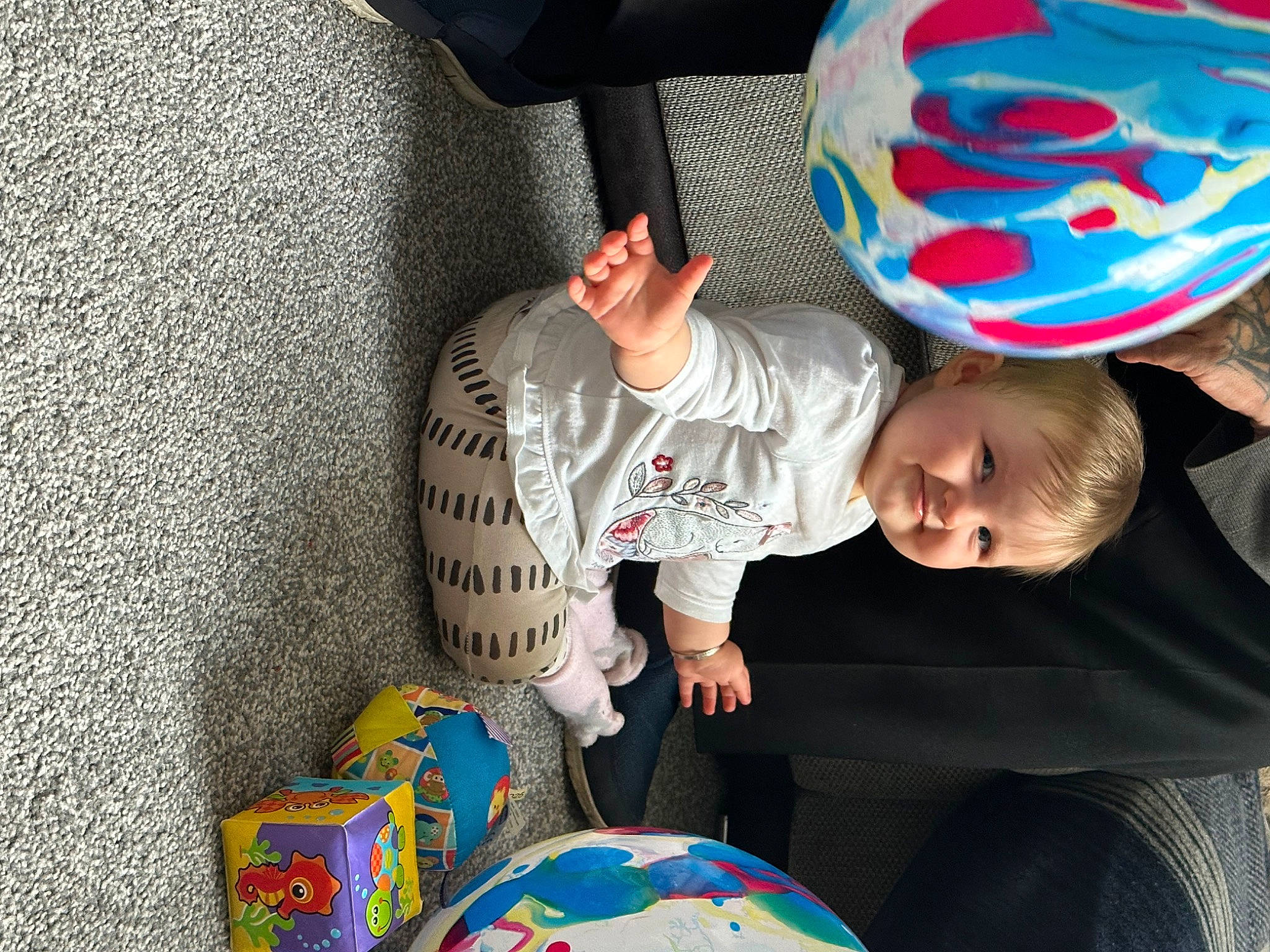 Evie joined the competition — help win amazing prizes! baby, baby_products, baby_toddler_clothing, child, comfort, electric_blue, flooring, fun, hat, joy, leisure, pattern, person, play, recreation, sitting, t_shirt, toddler, toy, world