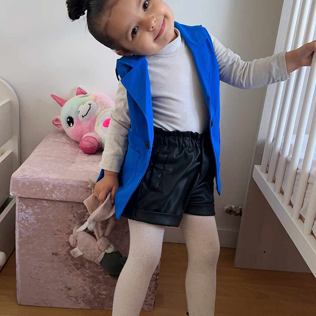 Shayana participe au concours pour gagner de l'argent avec cette photo : child, clothing, coat, crib, face, female, footwear, furniture, girl, hardwood, head, indoors, infantbed, pants, person, photography, portrait, shoe, shorts, wood