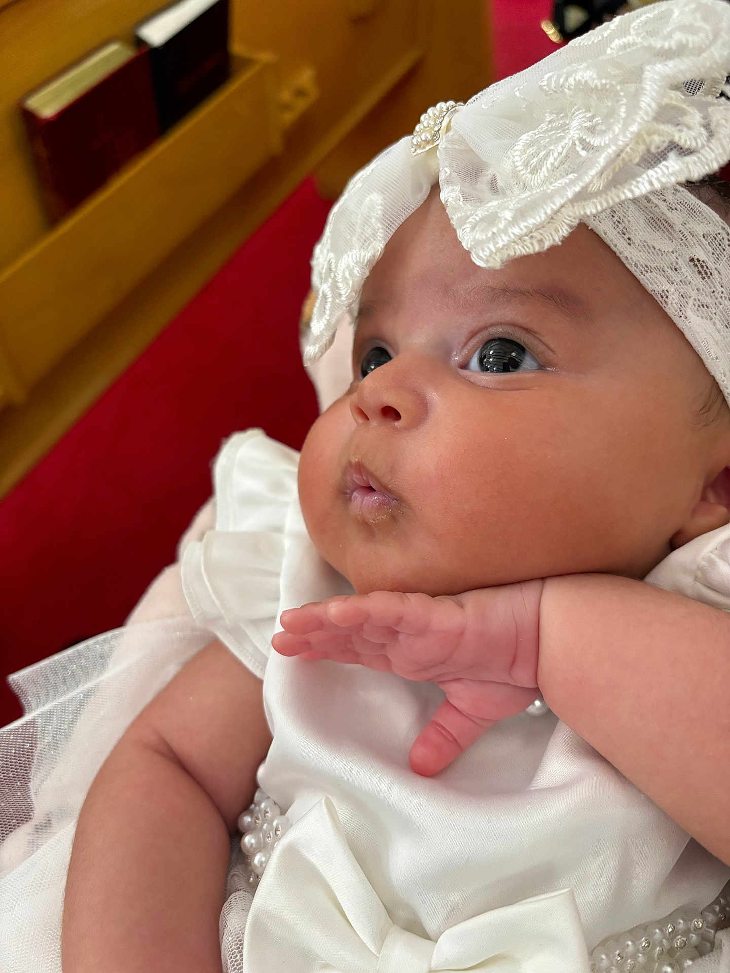 Autumn is registered to the contest to win money with this photo: baby, infant, white_dress, lace, pearls, closeup, chubby_cheeks, hand, cute, portrait, indoors, curious, gaze, soft_skin, headwear, bow, celebration, child, newborn, pink_skin