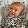 Hadley is registered to the contest to win money with this photo: baby, child, smiling, portrait, indoors, seated, floral_clothing, onesie, patterned_blanket, baby_seat, face, head, eyes, mouth, happy, infant, closeup, cozy, photography, winnie_the_pooh