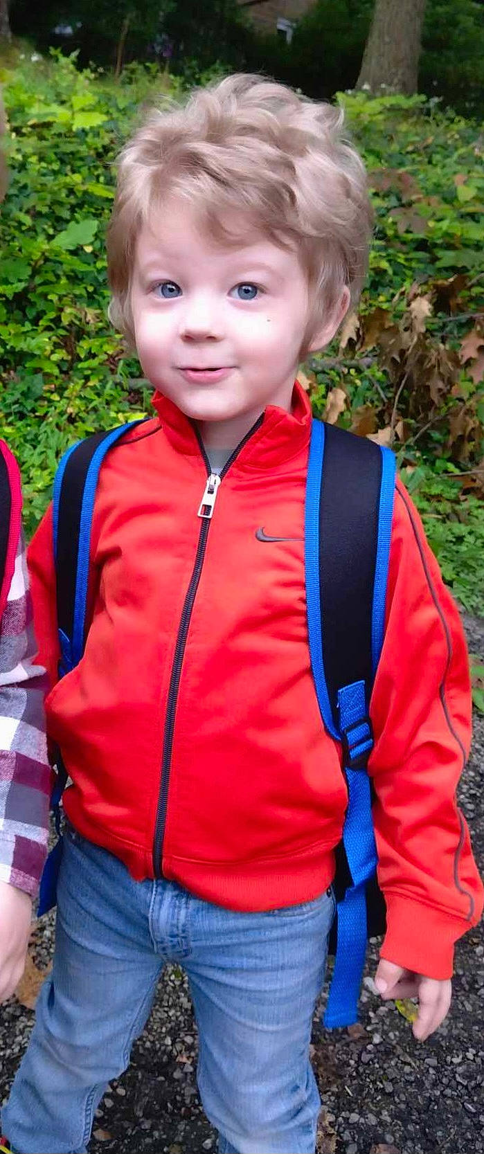 Isaiah is registered to the contest to win money with this photo: blue, chin, clothing, electric_blue, eye, grass, happy, joy, leaf, leisure, orange, organ, outerwear, people_in_nature, person, plant, red, sleeve, smile, t_shirt