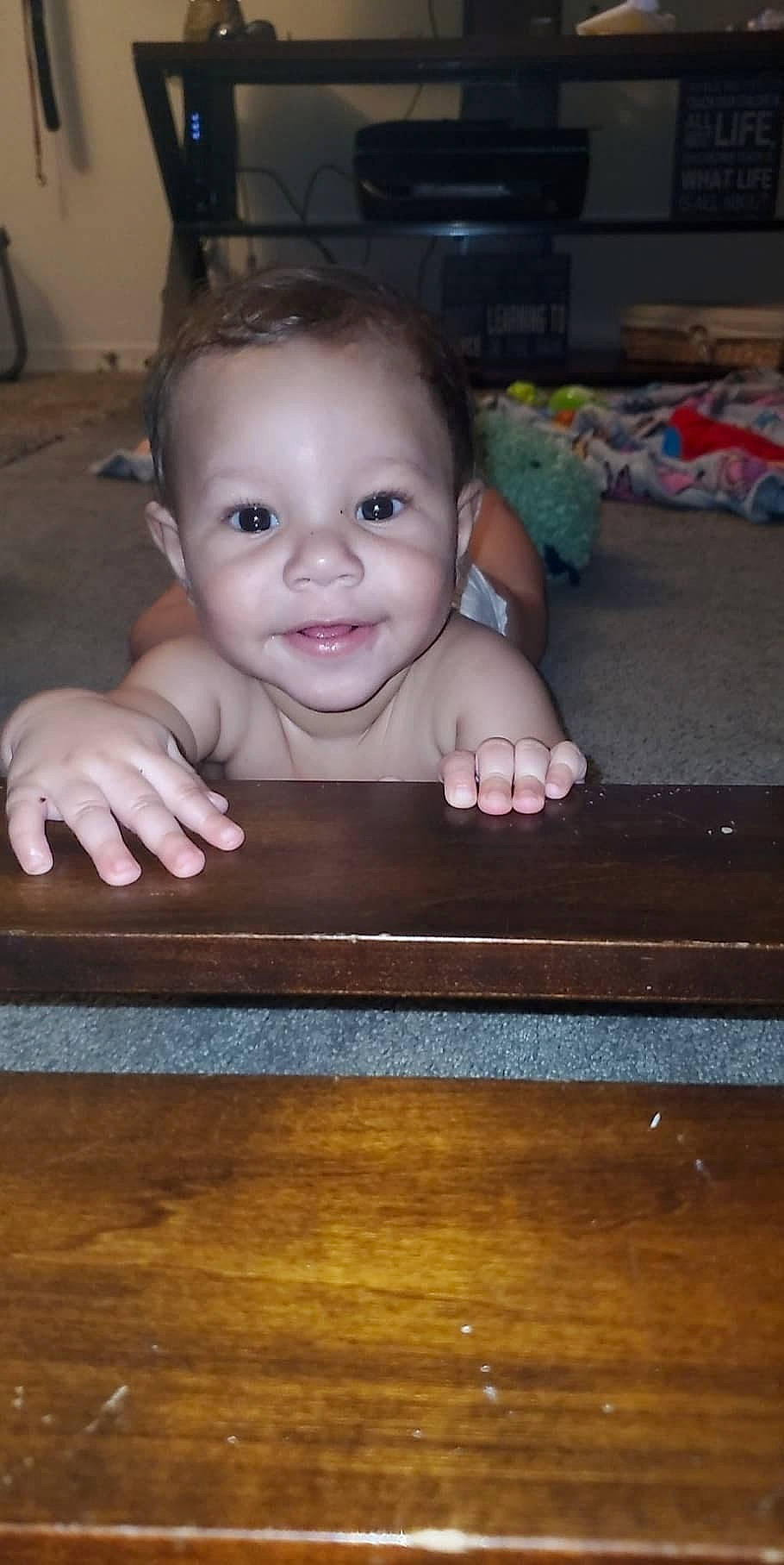 Huxlee is registered to the contest to win money with this photo: baby, cheek, child, eye, face, floor, fun, hardwood, head, joy, nose, person, play, sitting, skin, smile, toddler, wood
