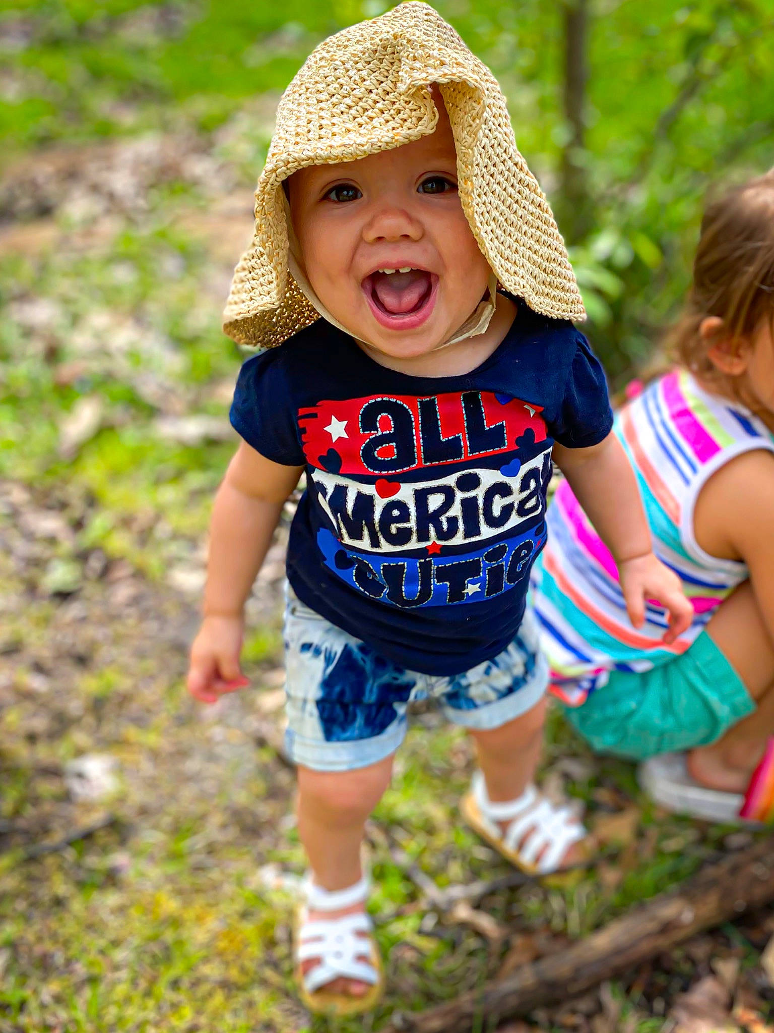 Maeslyn is registered to the contest to win money with this photo: baby_toddler_clothing, child, fun, grass, happy, headgear, headwear, pattern, people, person, plant, play, recreation, smile, summer, t_shirt, toddler, tree, vacation