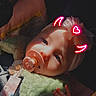 Harper joined the competition — help win amazing prizes! baby, pacifier, headband, plush_toy, child, infant, portrait, closeup, sunlight, soft_light, indoors, cute, hand, face, neon_effect, devil_horns, heart, accessory, sleepy, cozy
