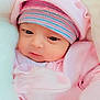 baby, newborn, infant, pink_clothing, hat, striped_hat, blanket, soft_texture, cute, face, eyes, sleepwear, cozy, child, portrait, young_child, warm, resting, bundle, closeup
