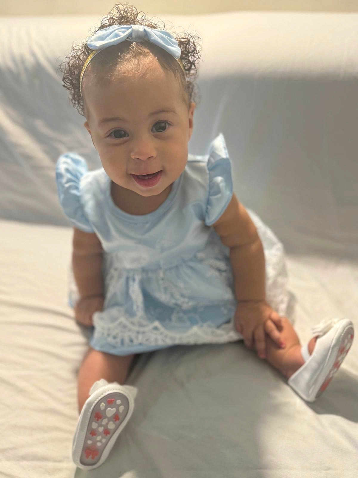 Lavinia participe au concours pour gagner de l'argent avec cette photo : baby, child, curly_hair, blue_dress, headband, smiling, white_shoes, sitting, lace, cute, indoors, portrait, young_child, happy, infant, fashion, footwear, light_background, person, toddler