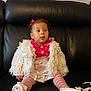 toddler, child, sitting, black_leather_couch, fluffy_jacket, pink_tights, shiny_skirt, bows, curly_hair, indoor, footwear, cute, portrait, young_child, clothing, fashion, person, expression, couch, furniture