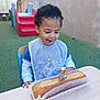 Laurentiu participe au concours pour gagner de l'argent avec cette photo : child, toddler, birthday, cake, candle, number_2, bib, table, outdoor, playground, smile, happy, curly_hair, food, celebration, chair, green_floor, wall, daylight, person