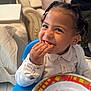 Laurentiu a rejoint le concours — aidez-le/la à gagner de superbes lots ! child, toddler, smile, eating, plate, food, high_chair, braided_hair, indoor, furniture, couch, pillow, person, clothing, tableware, happy, face, hand, home, snack