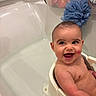 baby, bathtub, bath_seat, blue_pouf, child, cute, happy, infant, inside, joyful, laughing, person, portrait, sitting, smiling, water, young_child, skin, bathroom, head