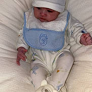 Noam participe au concours pour gagner de l'argent avec cette photo : baby, bear_hat, bear_slippers, bib, blanket, child, clothing, comfort, cozy, cute, hat, indoor, infant, pajamas, portrait, seated, sleepwear, slippers, soft, young_child