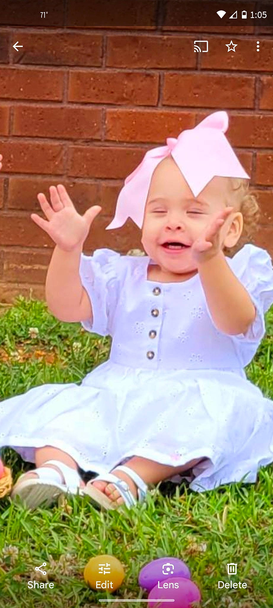 Sienna Joy Taylor is registered to the contest to win money with this photo: baby, baby_toddler_clothing, child, fun, gesture, grass, happy, laugh, pattern, people_in_nature, person, pink, sitting, sleeve, smile, toddler