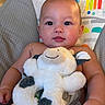 baby, child, stuffed_animal, plush_toy, colorful_background, rainbow, monkey, seat, cuddling, cute, infant, smiling, happy, indoors, portrait, chubby_cheeks, soft_toy, baby_seat, closeup, skin