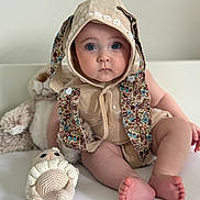 Elissa joined the competition — help win amazing prizes! baby, child, blue_eyes, bunny_ears, hood, cute_outfit, soft_toys, teddy_bear, crocheted_toy, lion_toy, sitting, portrait, indoors, white_background, soft_lighting, infant, face, feet, expression, adorable