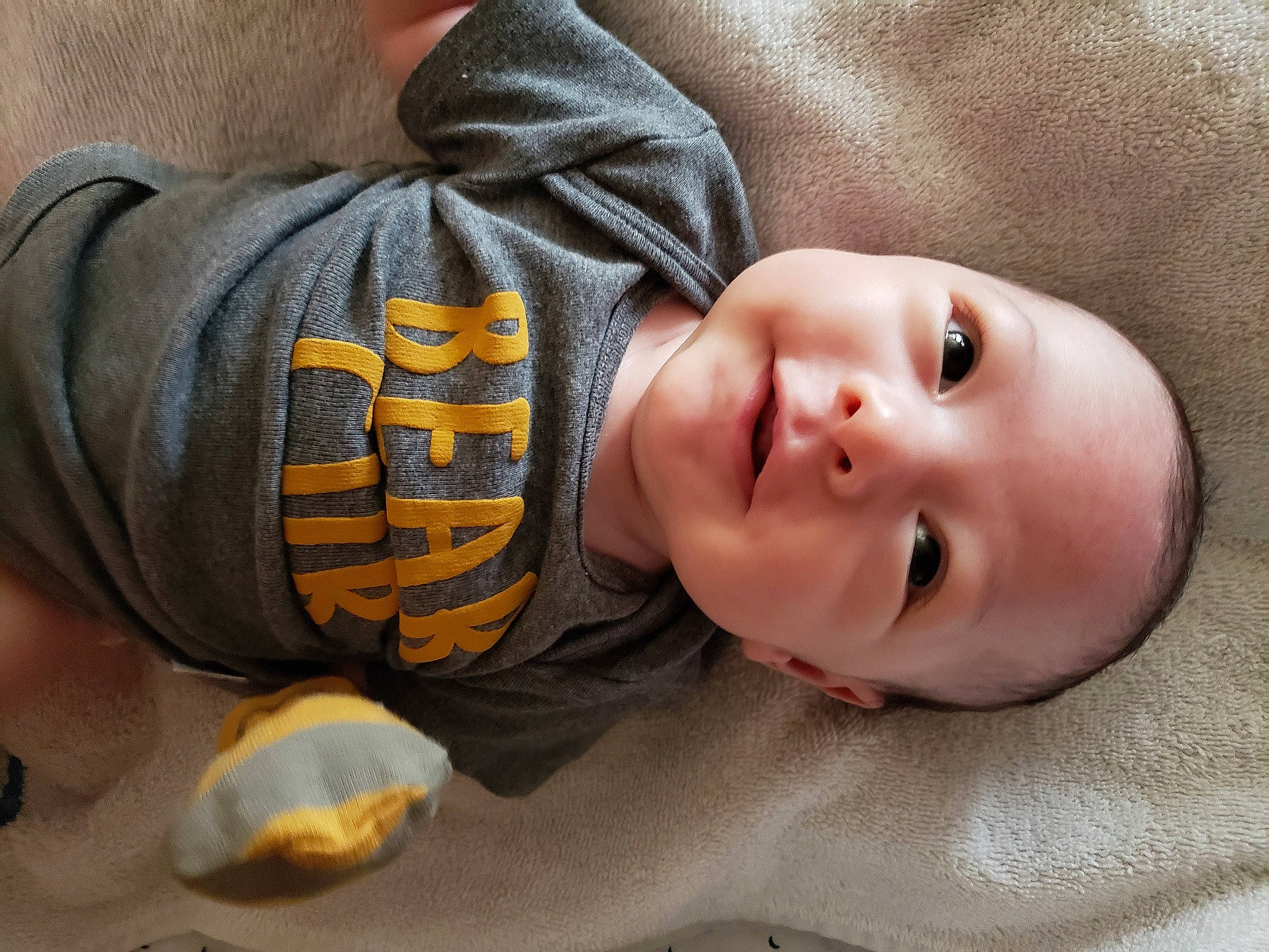 Jacob is registered to the contest to win money with this photo: baby, baby_toddler_clothing, cheek, child, comfort, elbow, eye, face, facial_expression, gesture, grass, headgear, human_body, mouth, nose, person, skin, sleeve, smile, toddler