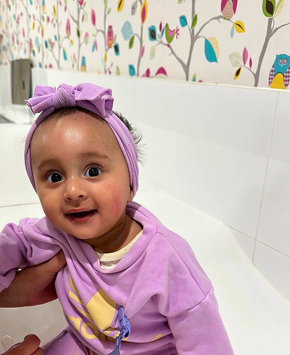 Amber is registered to the contest to win money with this photo: baby, baby_toddler_clothing, child, face, facial_expression, fashion_accessory, fun, gesture, hair_accessory, happy, headpiece, joy, magenta, person, pink, purple, selfie, sleeve, smile, textile