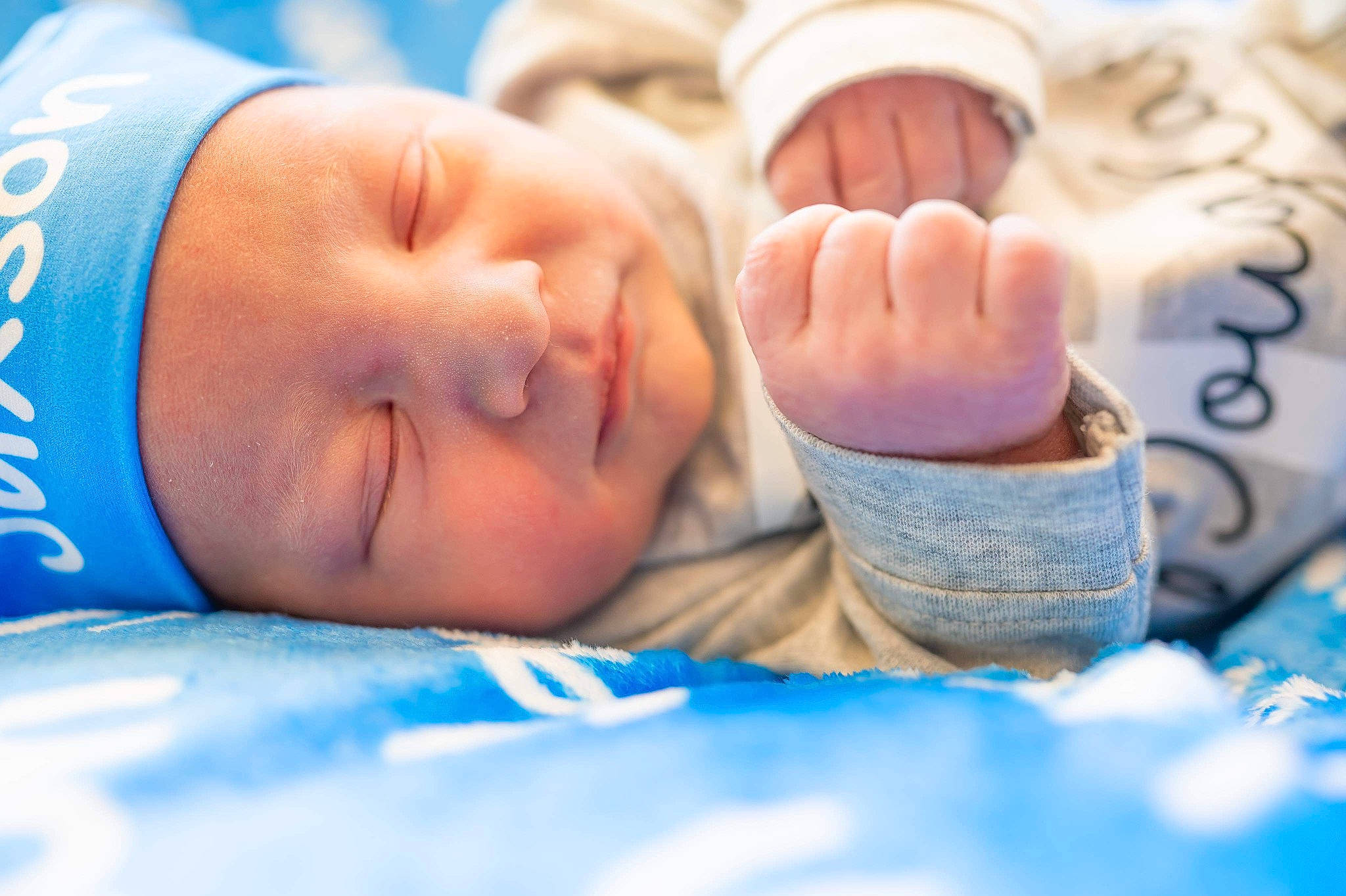 Jaxson is registered to the contest to win money with this photo: azure, baby, beauty, blue, child, close_up, comfort, electric_blue, finger, foot, fun, gesture, happy, hat, headwear, human_leg, nail, person, skin, smile