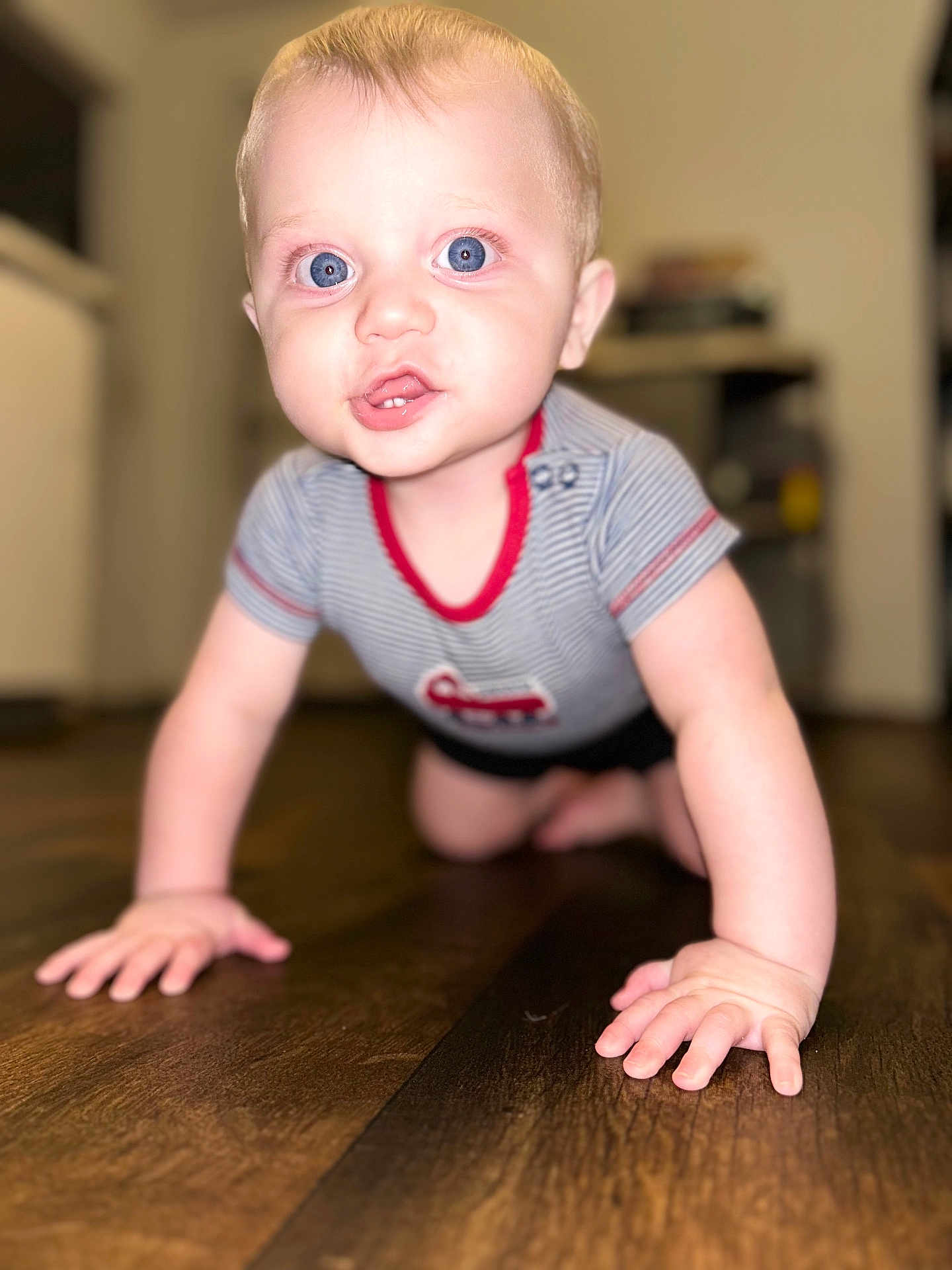 Noah joined the competition — help win amazing prizes! baby, child, crawling, blue_eyes, striped_shirt, floor, wooden_floor, indoor, cute, blond_hair, small_hands, infant, person, portrait, close_up, happy, bright_eyes, toddler, home, blurred_background